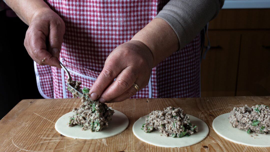 wise hands of a sicilian woman during the process of preparing pasticciotti during a cooking class