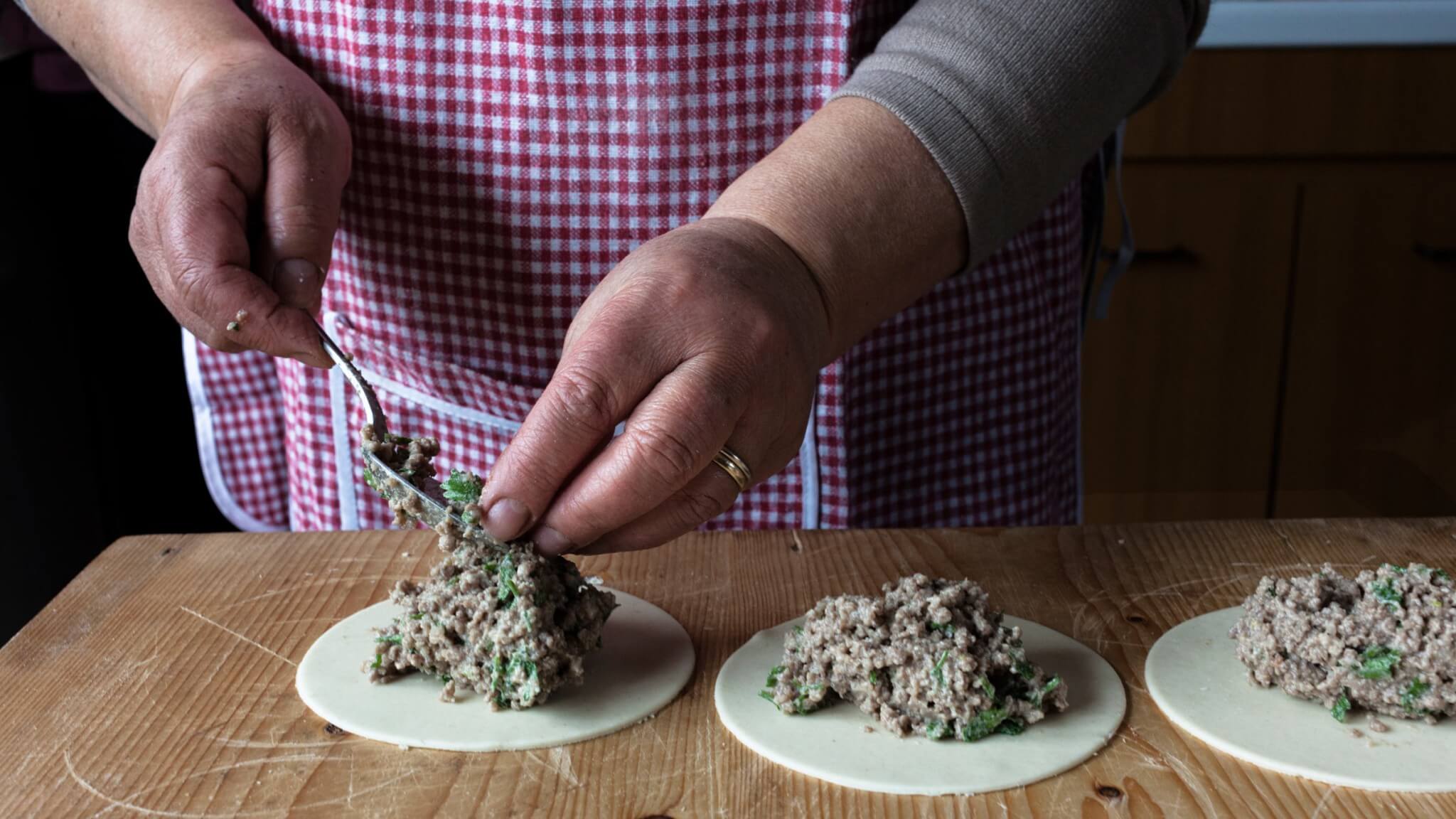 wise hands of a sicilian woman during the process of preparing pasticciotti during a cooking class
